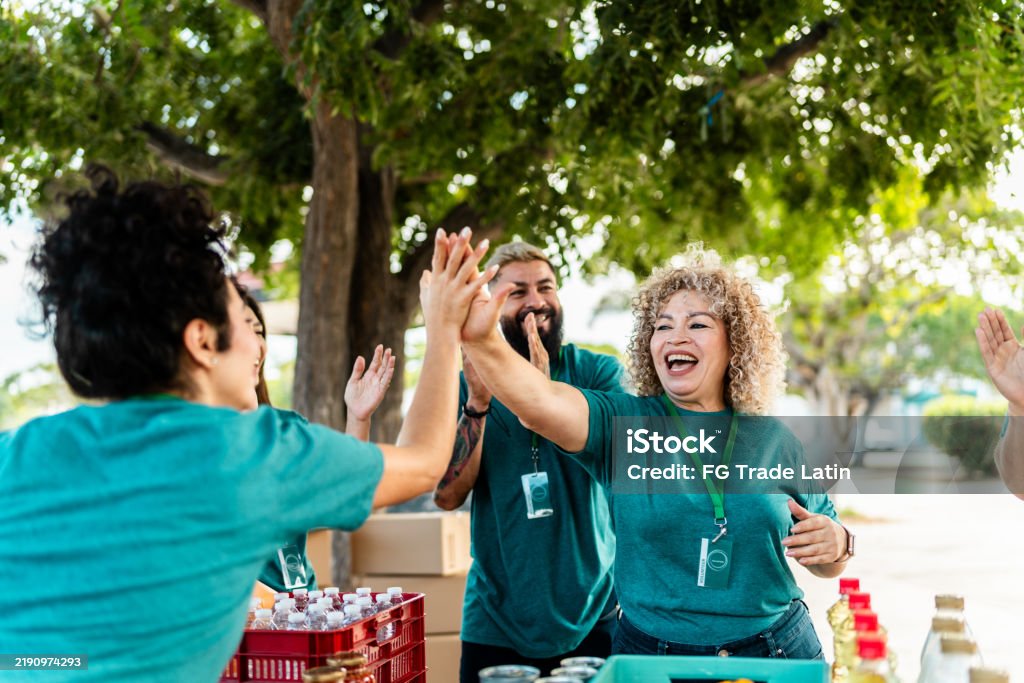 Volunteers smiling and cheering each other on at volunteer event