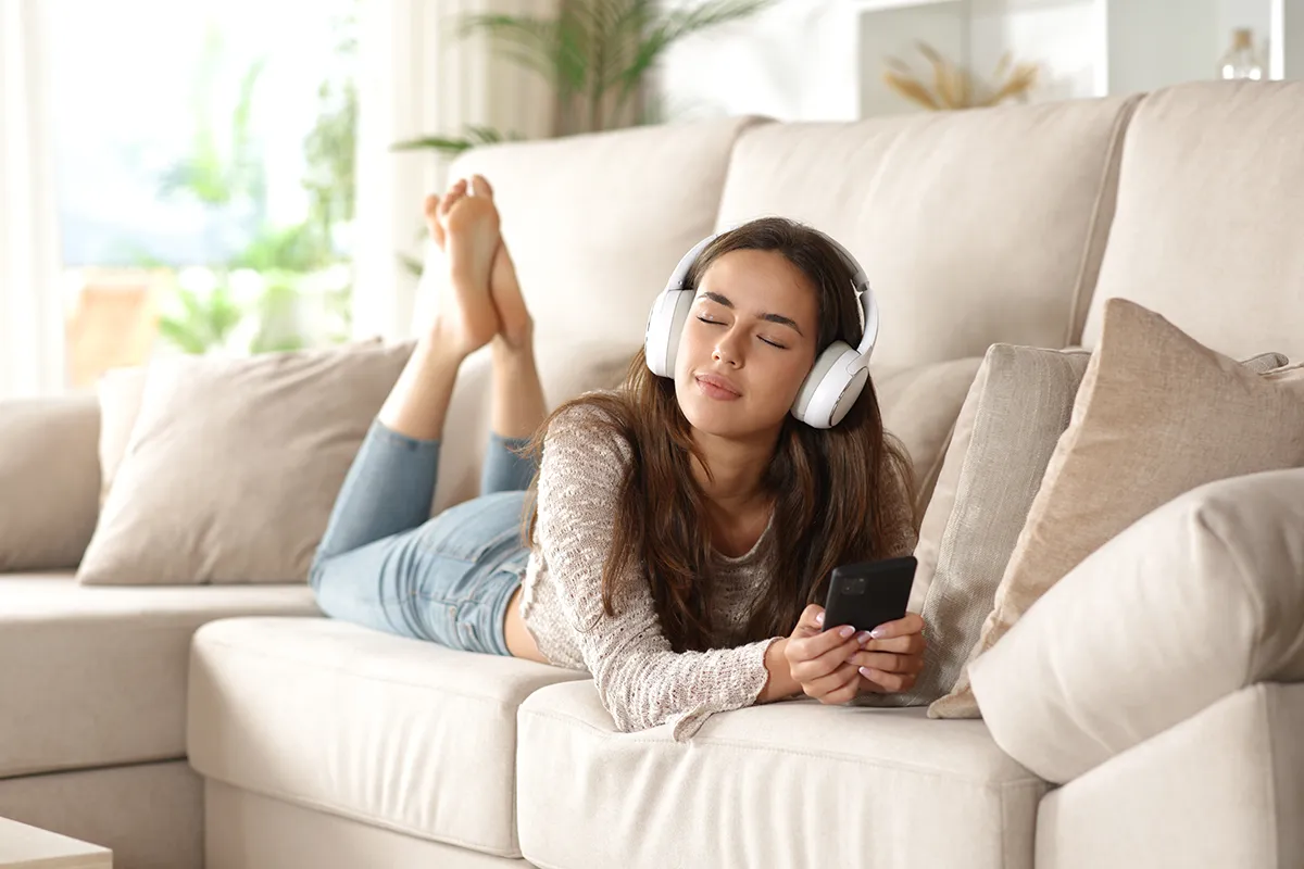 Girl on Sofa listening to music