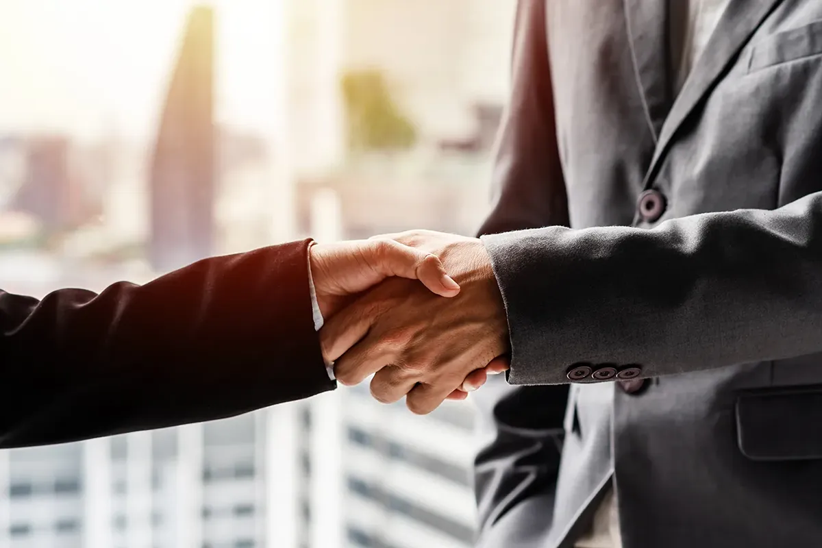 handshake in front of window