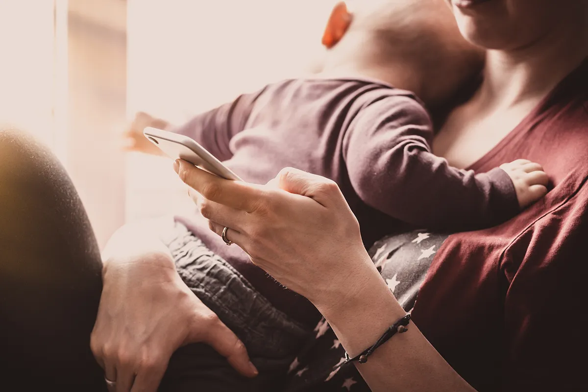 Mom holding a baby and a phone