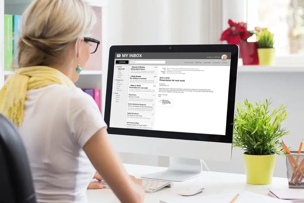 Woman checking emails on her computer.